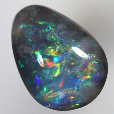 SOLID BLACK OPAL Bright red and orange sparkles over blue